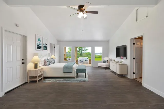 a living room with furniture fireplace and a large window