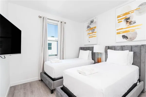 a bedroom with a bed and a flat screen tv