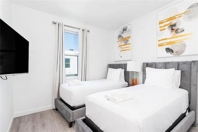 a bedroom with a bed and a flat screen tv