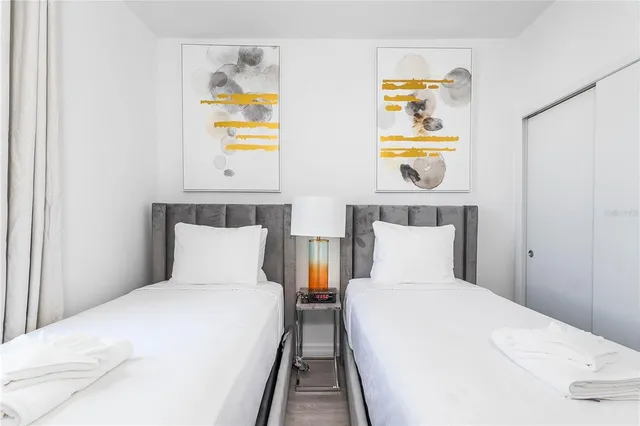 a bedroom with a bed and painting on the wall