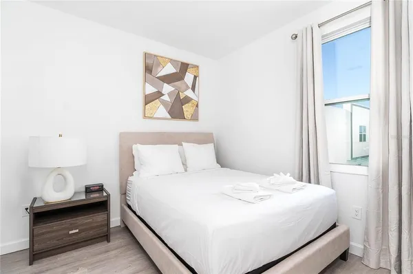 a bedroom with a bed and a window