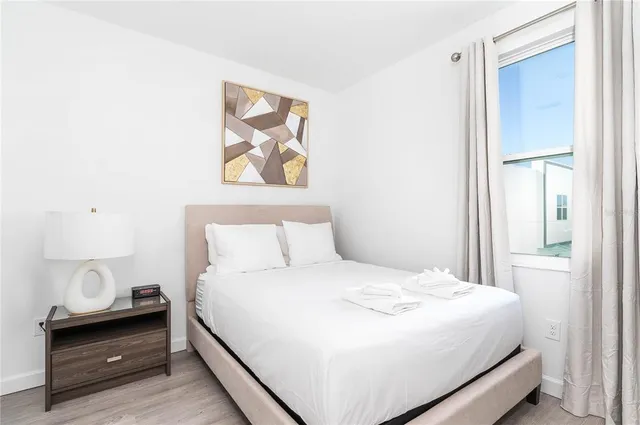 a bedroom with a bed and a window