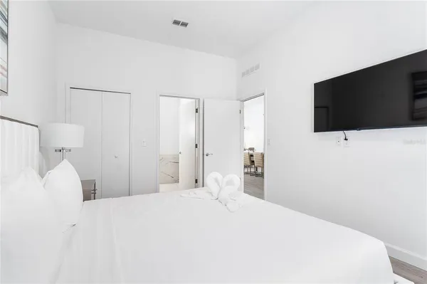 a bedroom with a bed and a flat screen tv