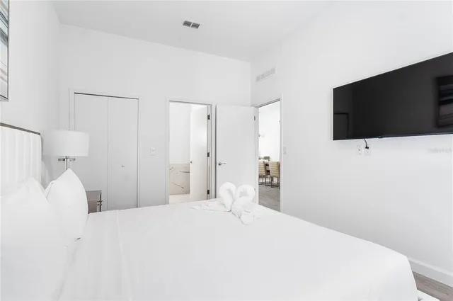 a bedroom with a bed and a flat screen tv