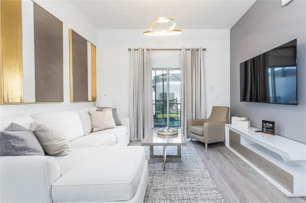 a living room with furniture and a flat screen tv