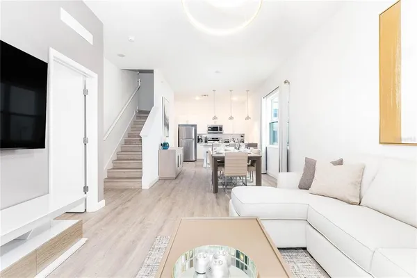 a living room with furniture and a flat screen tv