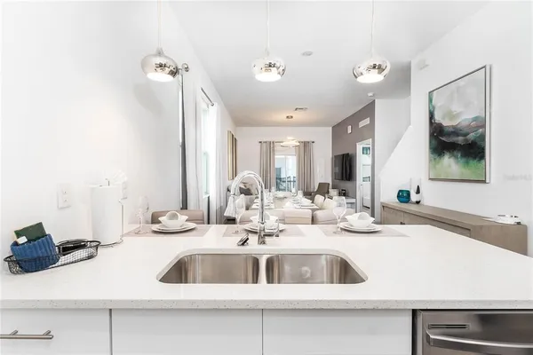 a kitchen with a sink and a mirror