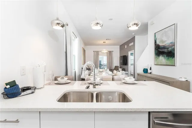 a kitchen with a sink and a mirror