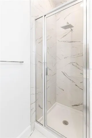 a bathroom with a glass shower door
