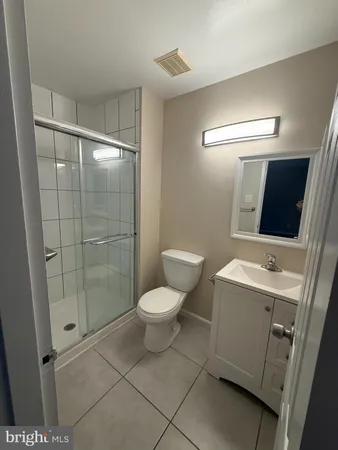 a bathroom with a toilet sink and shower