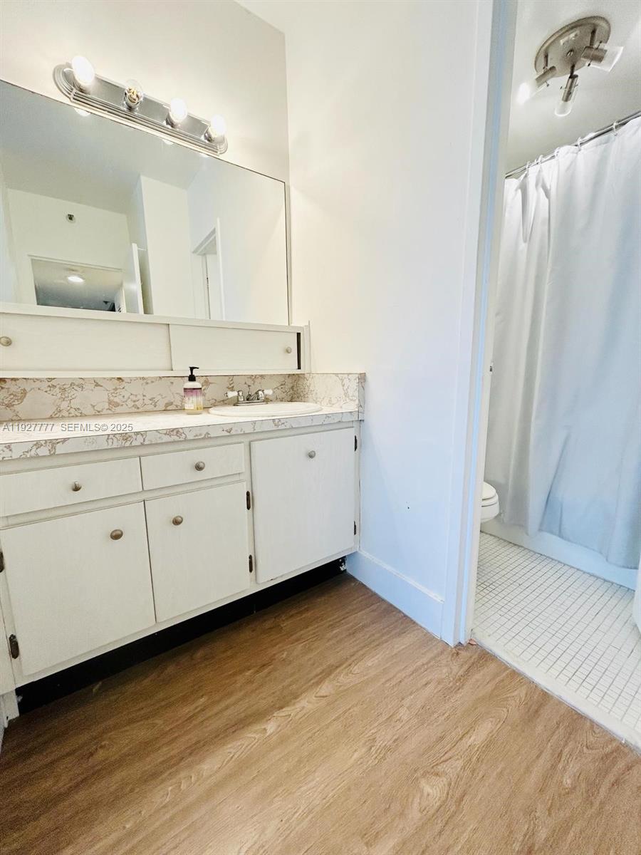 100 Lincoln Road, Unit 922 Miami Beach, FL 33139 - Photo 6 of 10 a bathroom with a granite countertop sink and a mirror