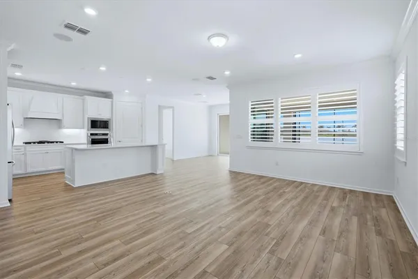 a view of kitchen with wooden floor and window