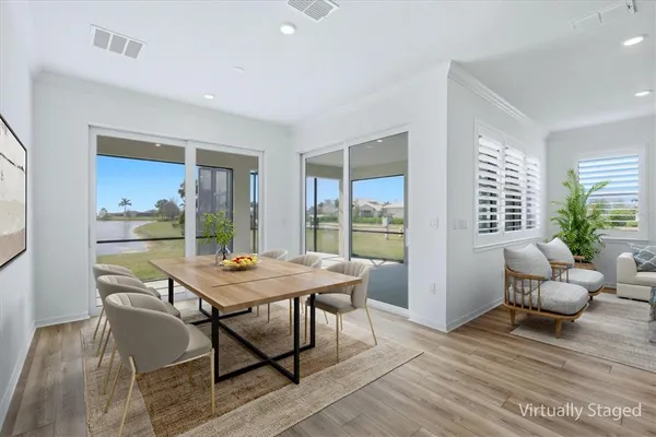 a view of a dining room with furniture window and wooden floor