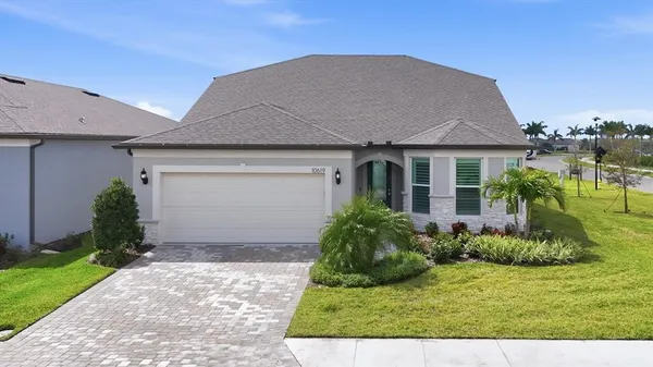a front view of house with yard and green space