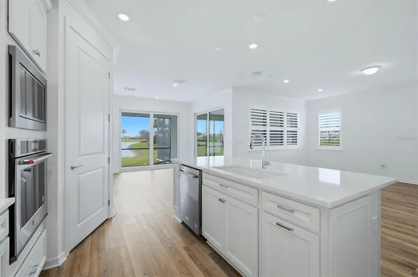 a bathroom with a double vanity sink a large mirror and a bathtub