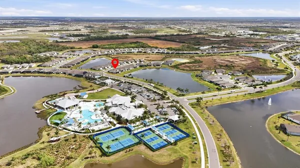 a living room with furniture a flat screen tv and a table
