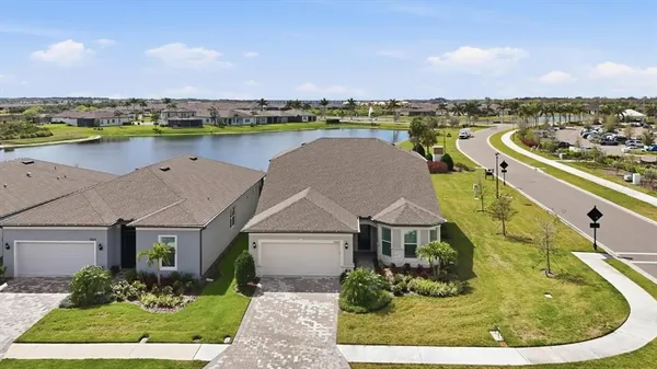 an aerial view of a house with outdoor space and lake view