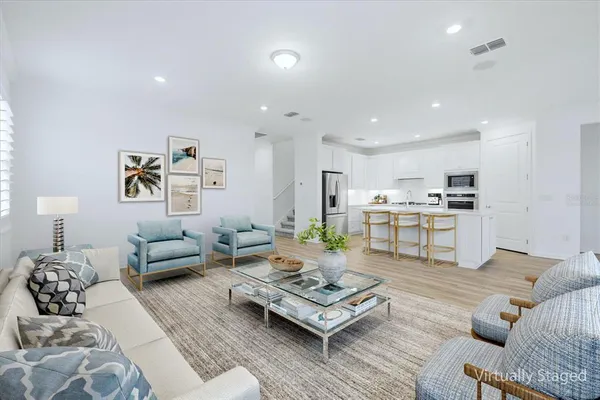 a living room with furniture kitchen view and a table