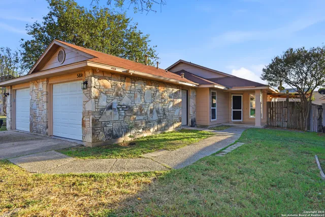 a view of a house with a yard