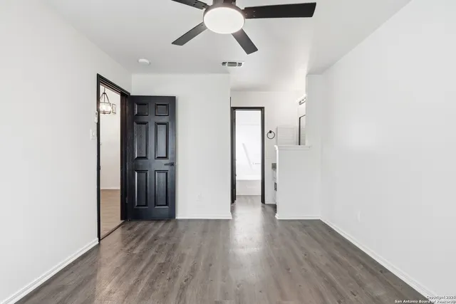 a view of empty room with wooden floor