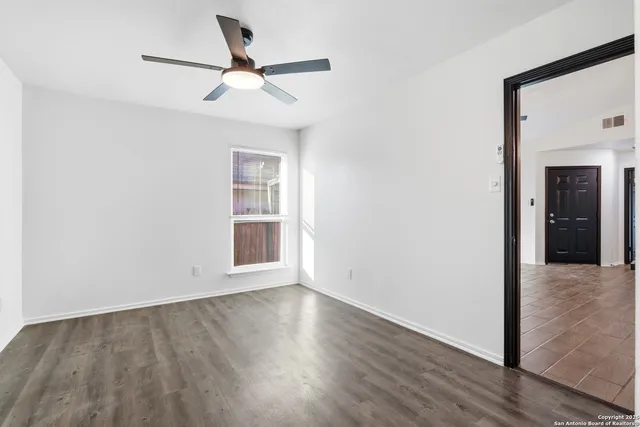 wooden floor in an empty room with a window