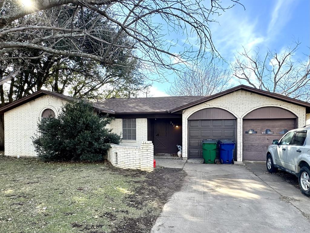 317 North Trail Street Crowley, TX 76036 - Photo 1 of 35 a front view of a house with a yard and garage