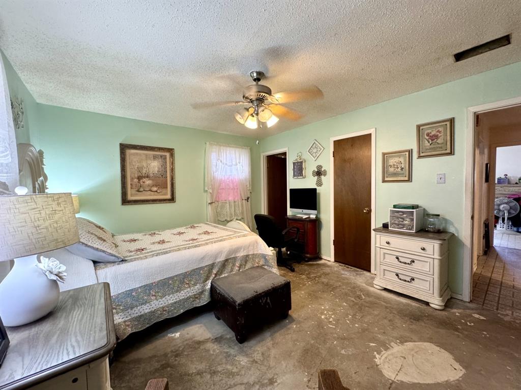 317 North Trail Street Crowley, TX 76036 - Photo 17 of 35 a bedroom with a bed dresser and wooden floor