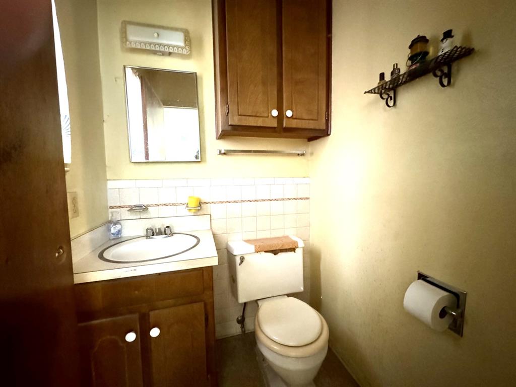 317 North Trail Street Crowley, TX 76036 - Photo 18 of 35 a bathroom with a toilet sink and mirror