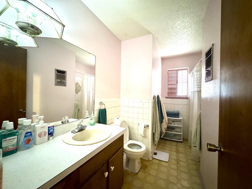 317 North Trail Street Crowley, TX 76036 - Photo 24 of 35 a bathroom with a sink toilet and shower