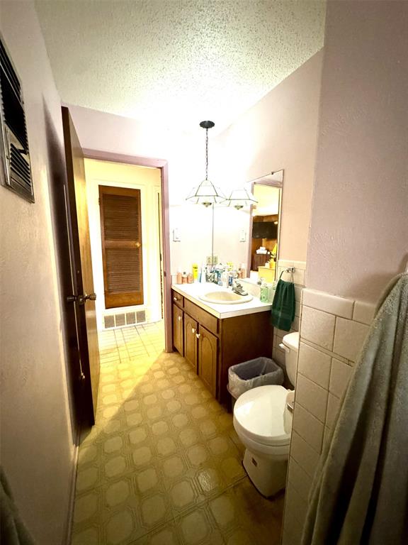 317 North Trail Street Crowley, TX 76036 - Photo 26 of 35 a bathroom with a sink a toilet and mirror