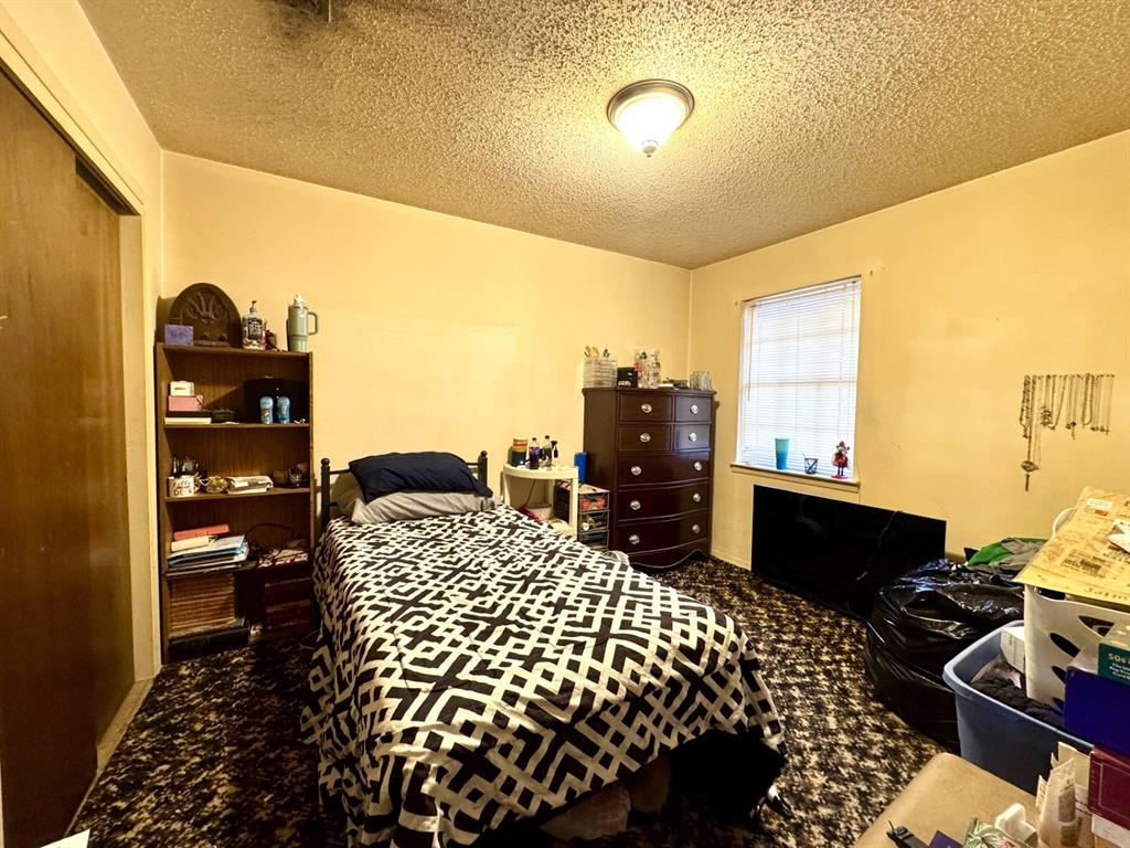 317 North Trail Street Crowley, TX 76036 - Photo 27 of 35 a bed room with a bed and a television
