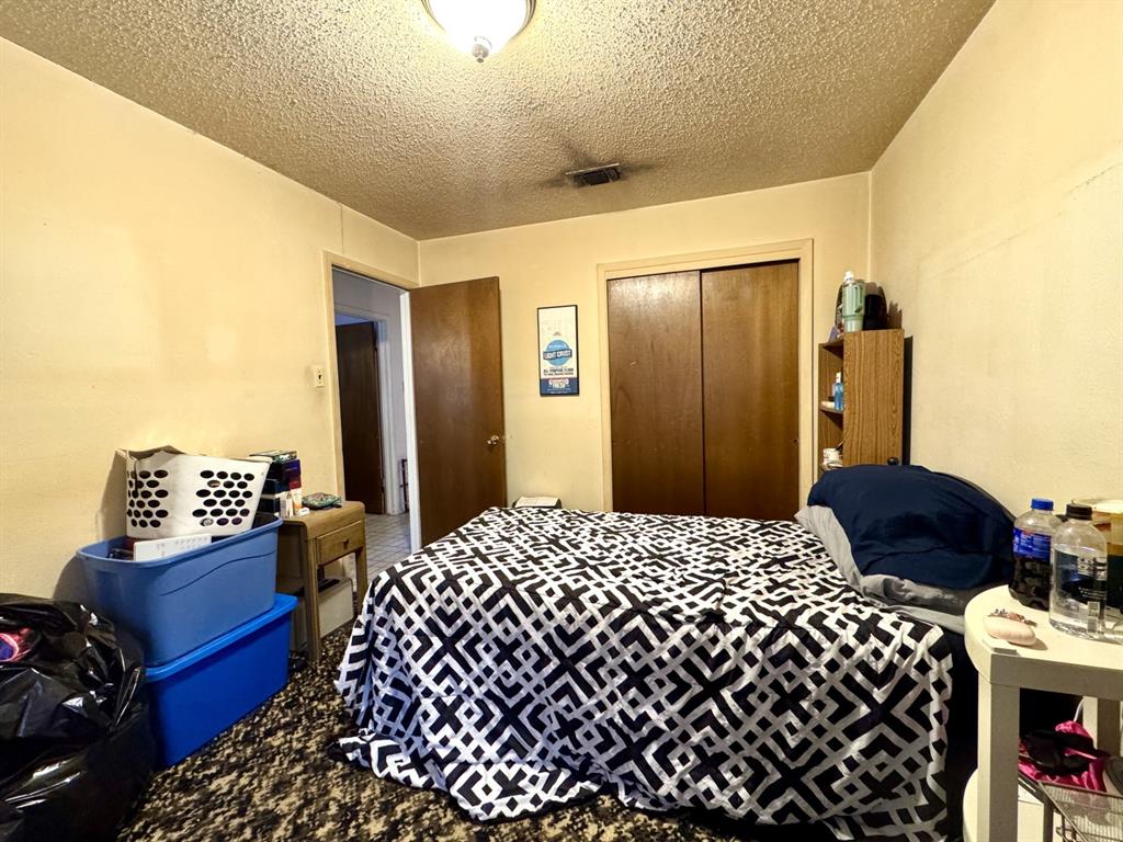 317 North Trail Street Crowley, TX 76036 - Photo 28 of 35 a bedroom with a bed and wooden floor