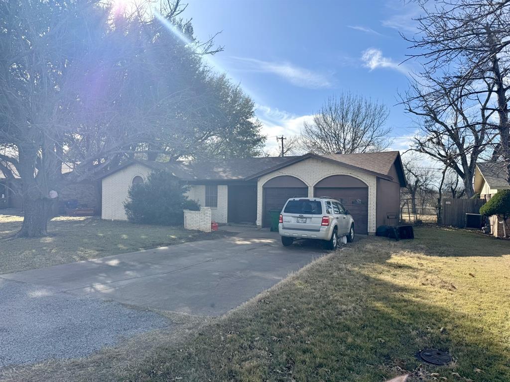 317 North Trail Street Crowley, TX 76036 - Photo 29 of 35 a front view of a house with a yard and garage