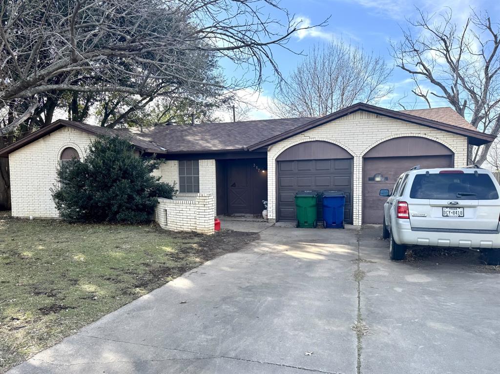 317 North Trail Street Crowley, TX 76036 - Photo 33 of 35 a front view of a house with a yard and garage