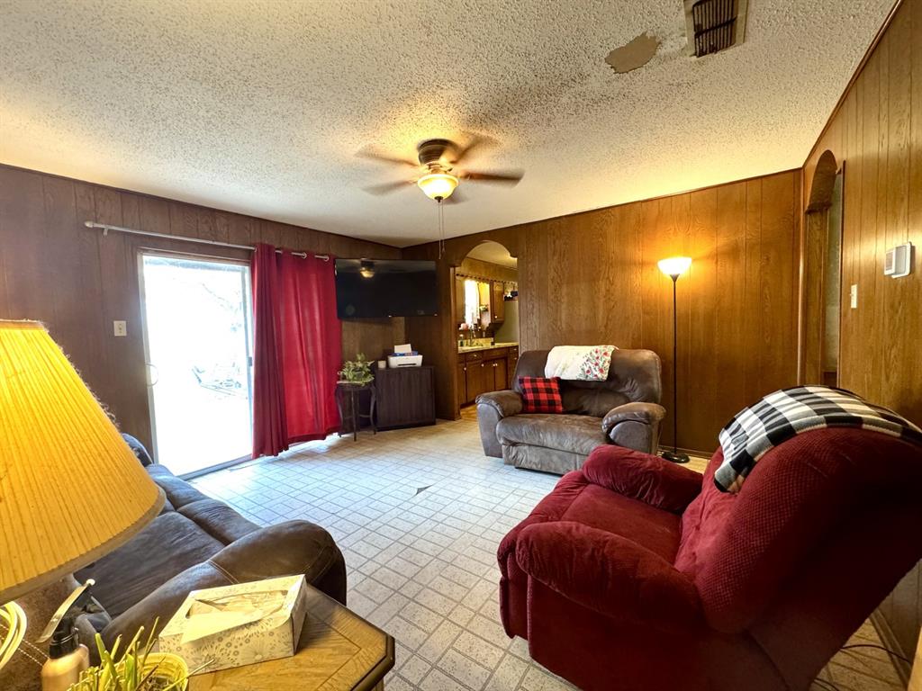 317 North Trail Street Crowley, TX 76036 - Photo 6 of 35 a living room with furniture and a chandelier