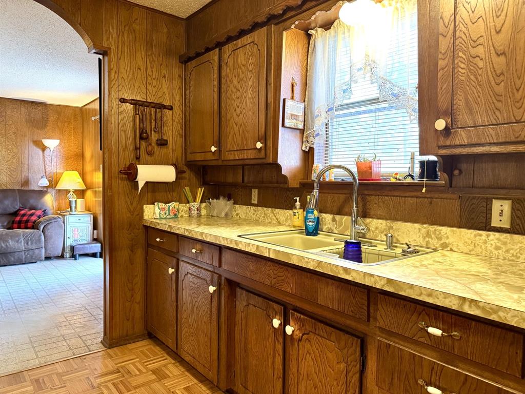 317 North Trail Street Crowley, TX 76036 - Photo 9 of 35 a bathroom with a granite countertop sink and a mirror