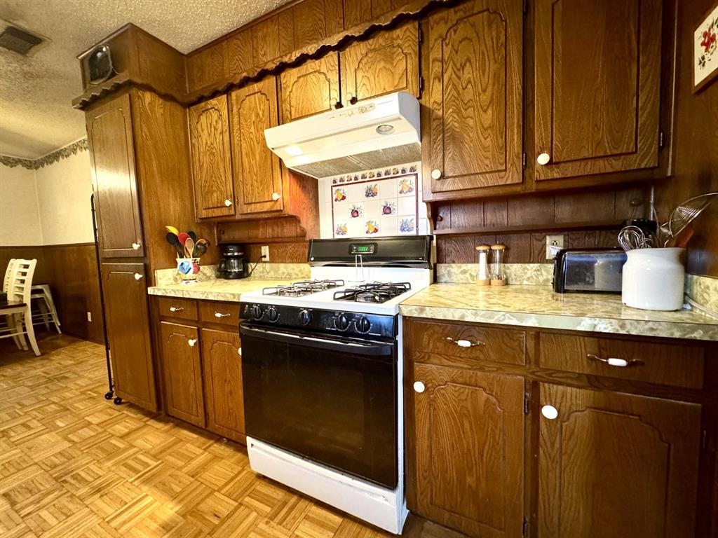 317 North Trail Street Crowley, TX 76036 - Photo 10 of 35 a kitchen with stainless steel appliances granite countertop a sink stove and cabinets