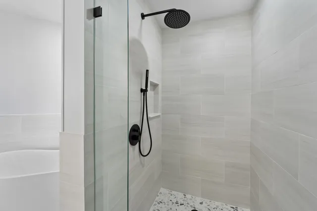 a view of a livingroom with furniture window and a ceiling fan