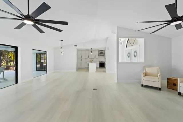 a large white kitchen with cabinets