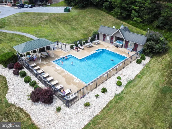 an aerial view of a house with yard swimming pool and outdoor seating