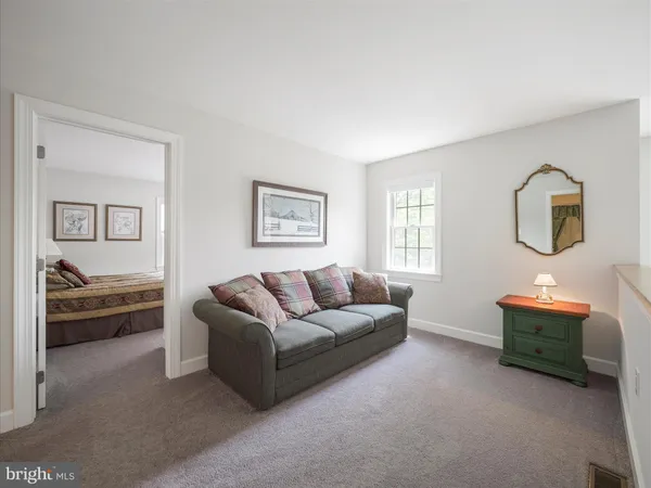a bedroom with a large bed and curtain