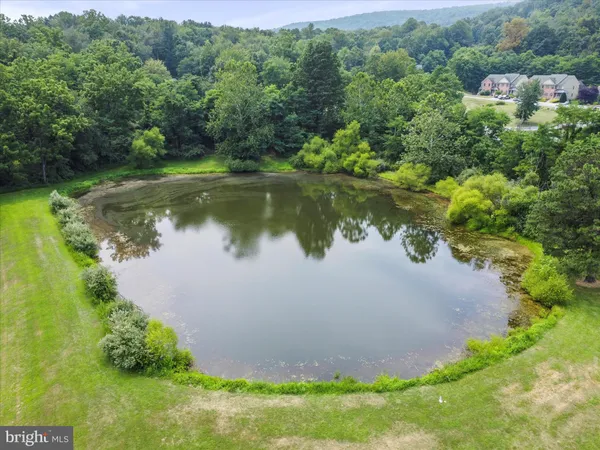 a view of house with swimming pool and yard