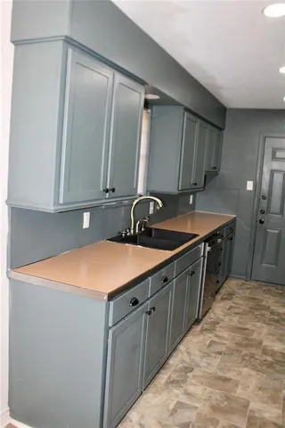a kitchen with a sink and cabinets
