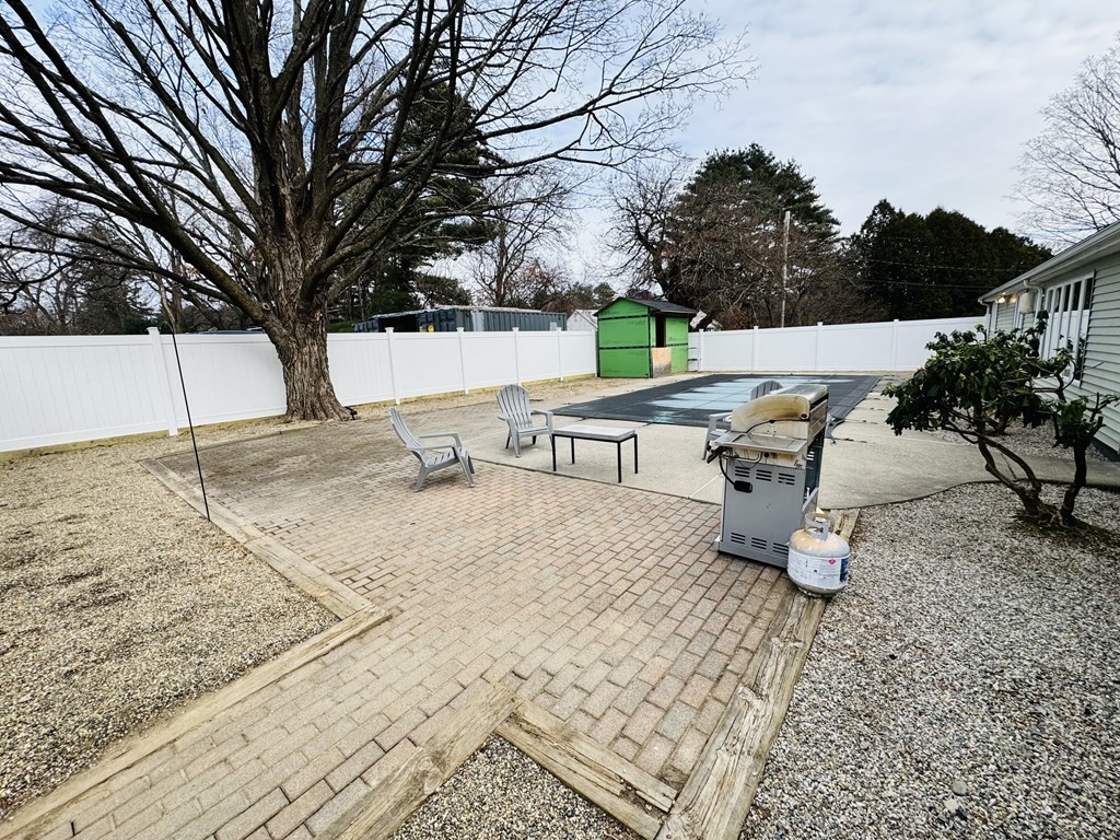 10 Robert Road Framingham, MA 01702 - Photo 19 of 20 a view of a terrace with a bench and trees