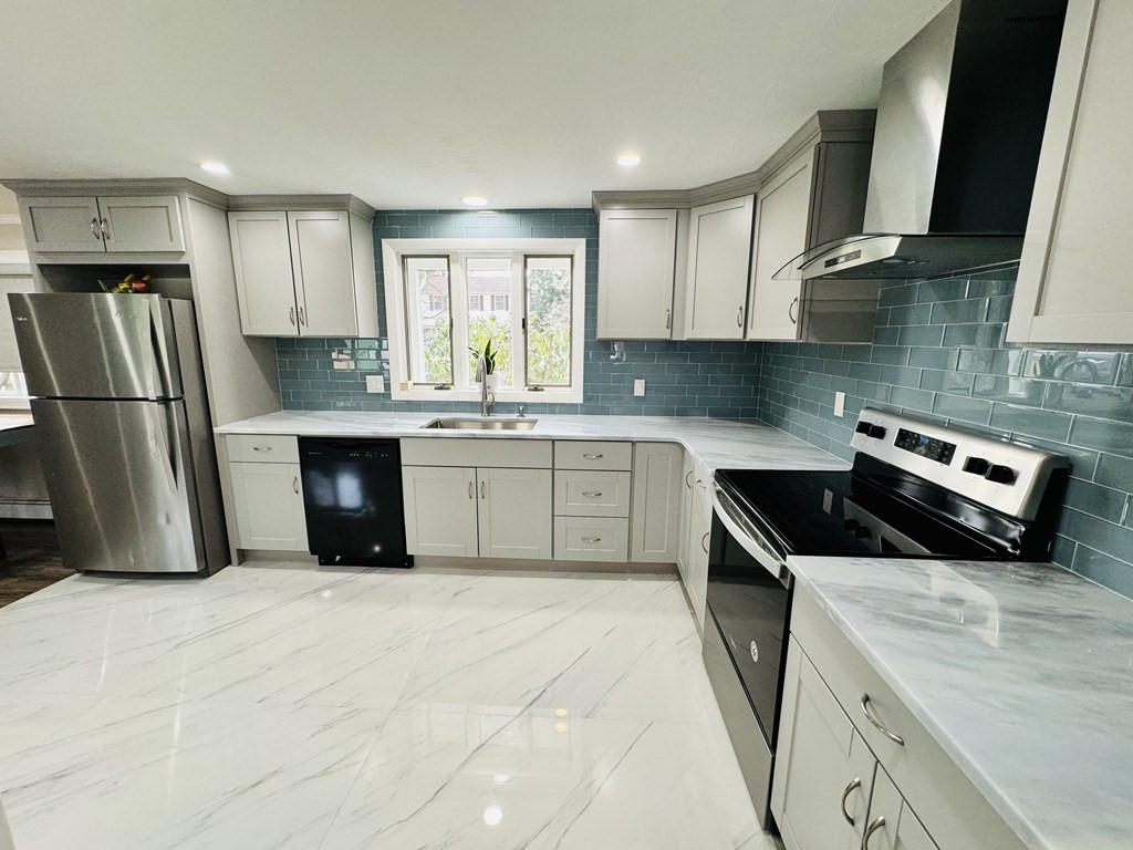 10 Robert Road Framingham, MA 01702 - Photo 7 of 20 a kitchen with stainless steel appliances granite countertop a sink stove and refrigerator