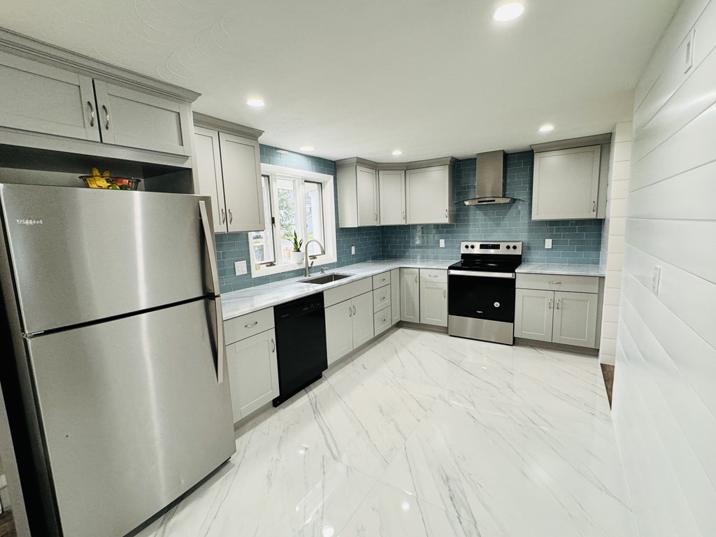 10 Robert Road Framingham, MA 01702 - Photo 8 of 20 a kitchen with stainless steel appliances granite countertop a refrigerator sink stove and cabinets