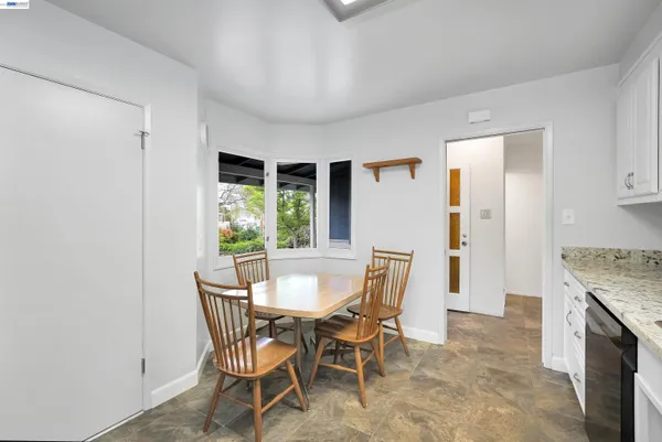 a dining room with furniture and window
