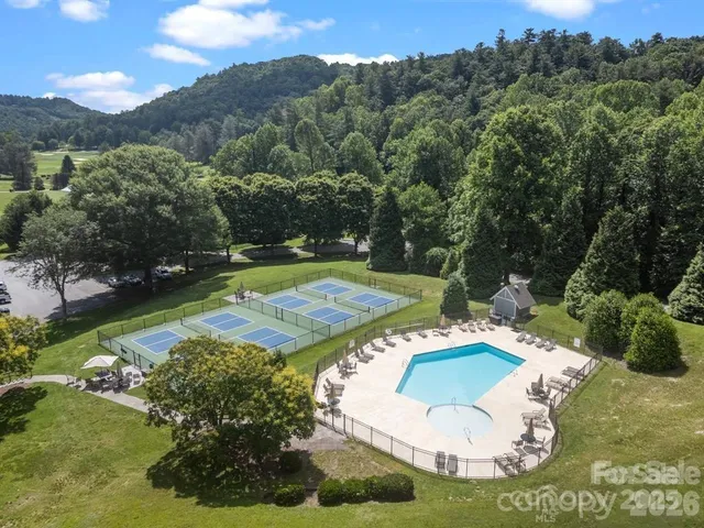 a view of a yard with wooden fence
