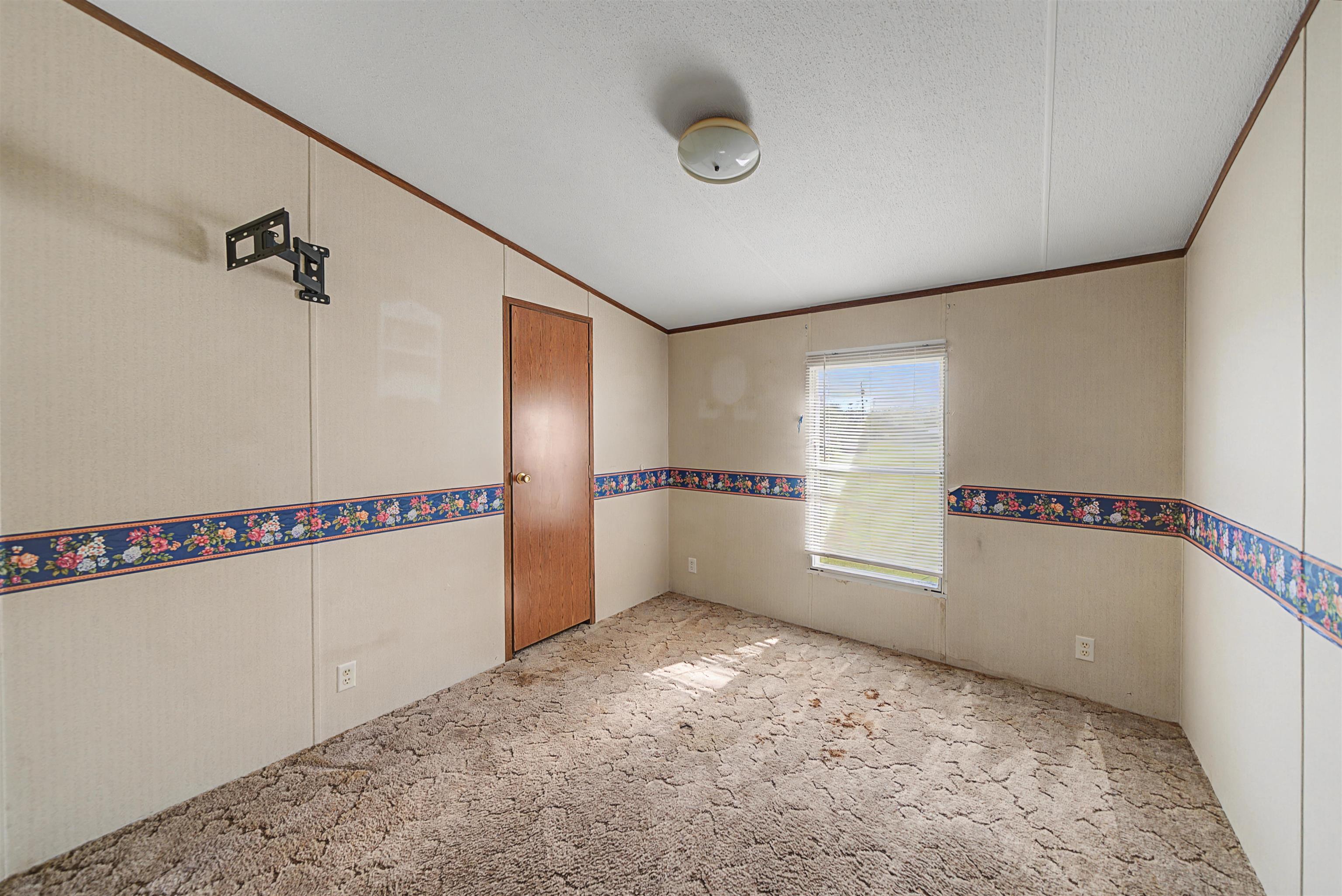 1788 Nichols Road Guys, TN 38339 - Photo 16 of 21 Spare room featuring light colored carpet and crown molding