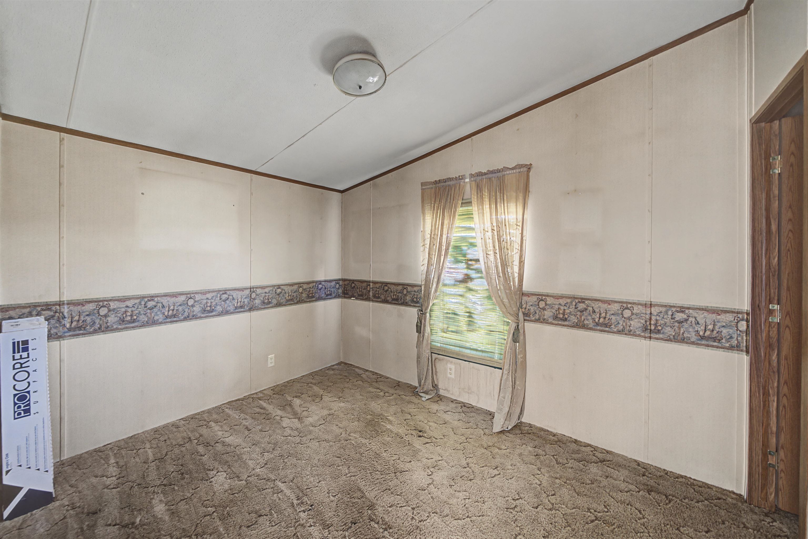 1788 Nichols Road Guys, TN 38339 - Photo 18 of 21 Carpeted spare room with a decorative wall and lofted ceiling